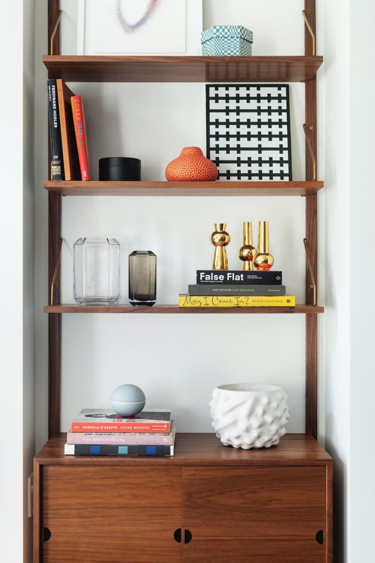 Shelving system detail with books and art objects