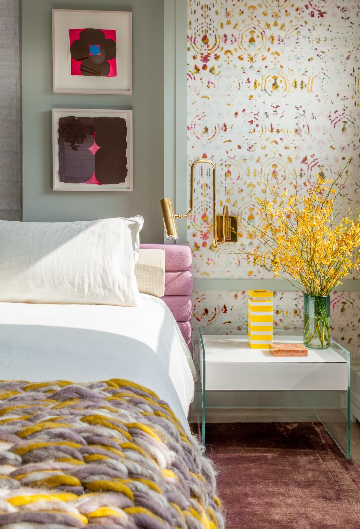Detail of bed with bedside table and light streaming in