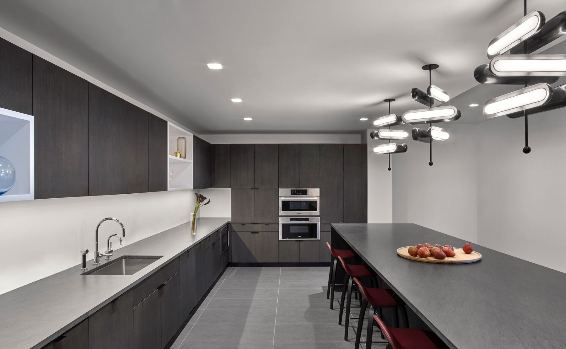 Workplace kitchen with lots of counterspace and cabinets and seating at island
