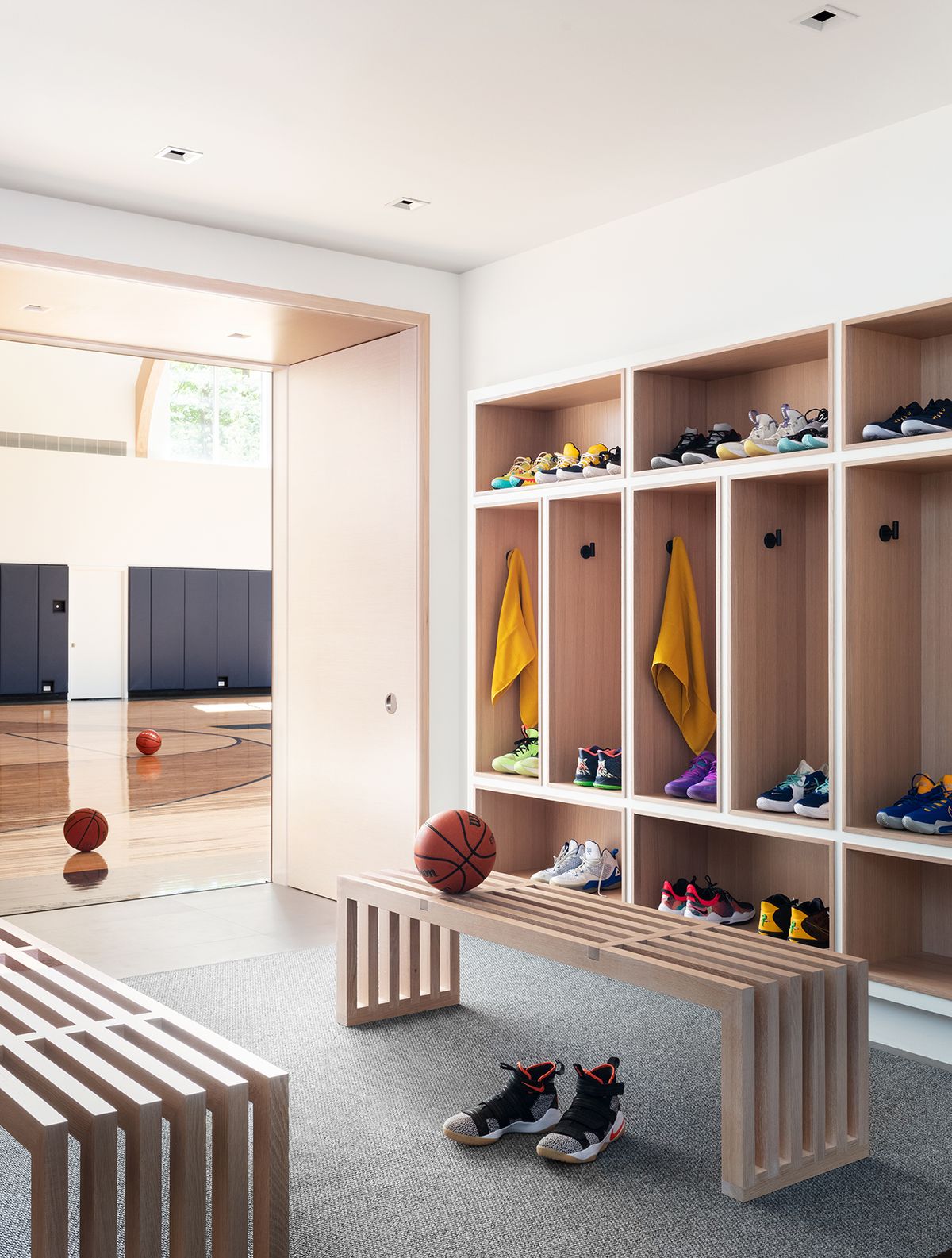 Built in open-face lockers and modern slatted wood benches