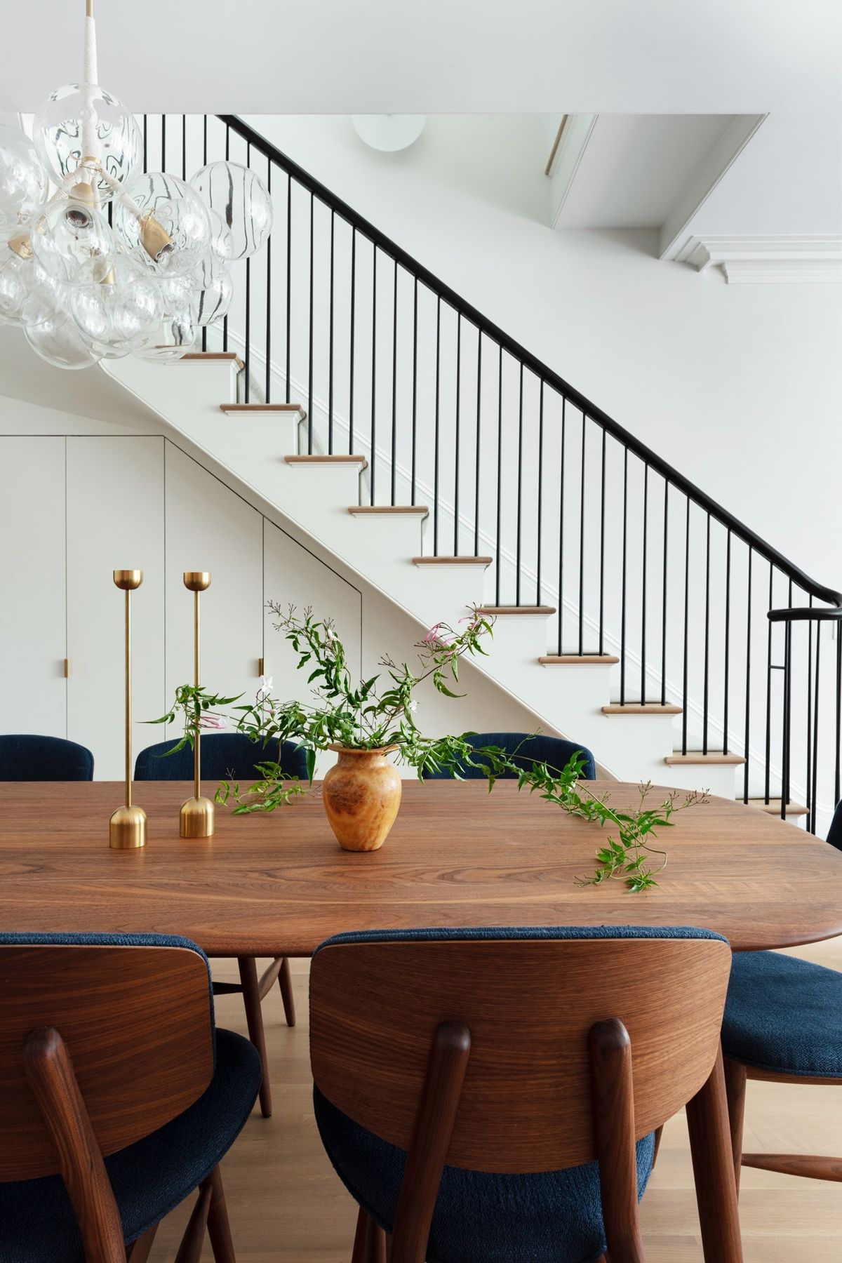 Stair in background and dining table and chairs in foregroung