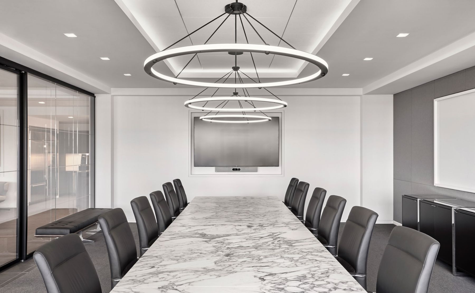 Conference room with marble-top conference table and leather seating