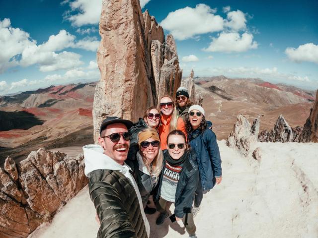 A group of people standing on a rocky mountain.