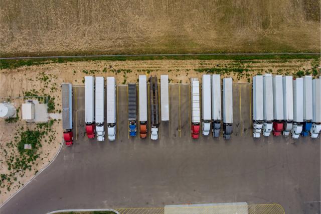 A large parking lot with many trucks parked in it.