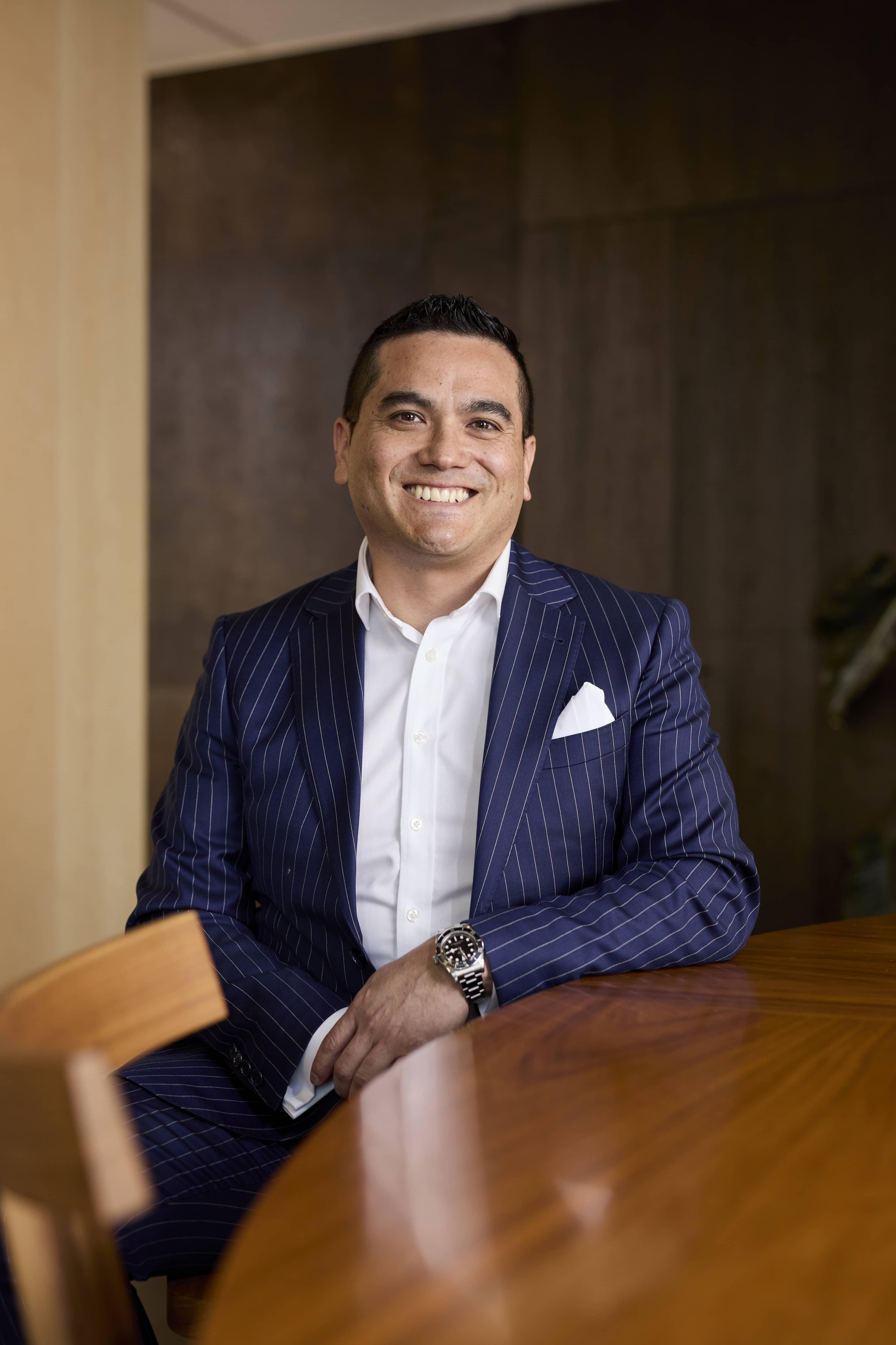 Man in a suit sitting on a chair in an office