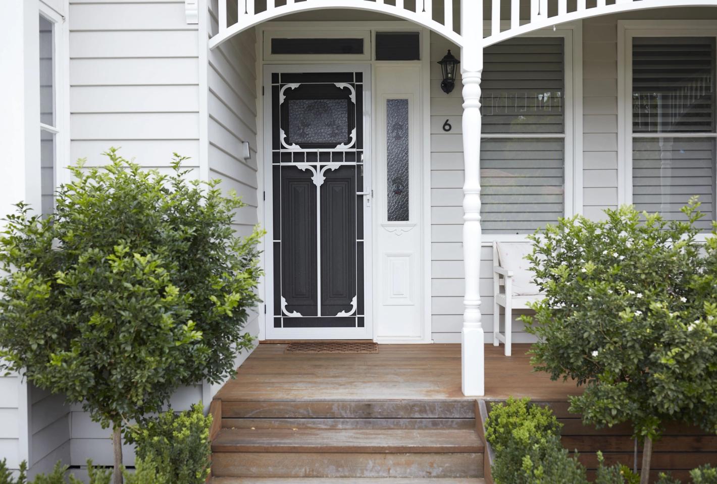 The front of a white weatherboard house