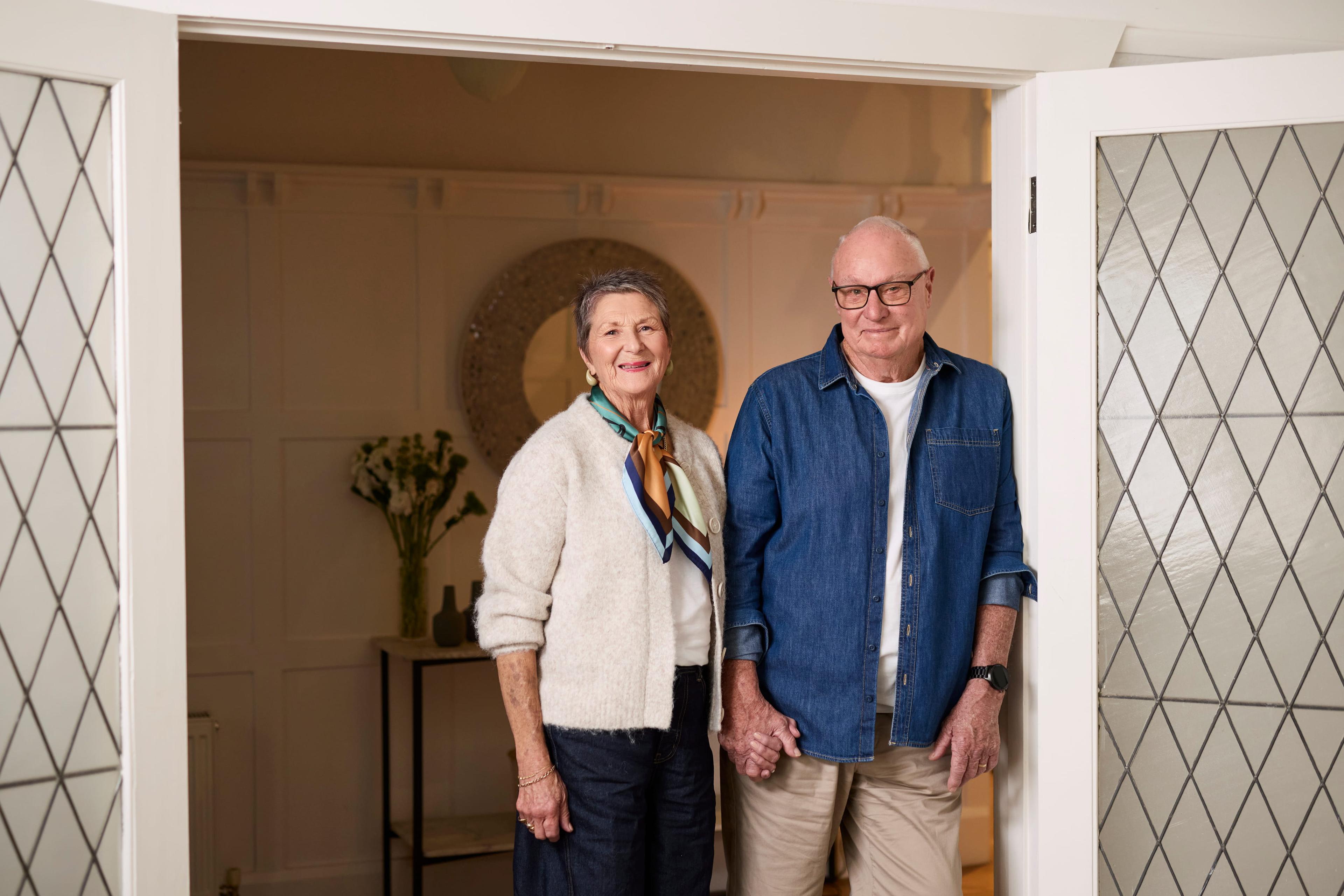 Household Capital customers Jim and Barbara stand in a doorway