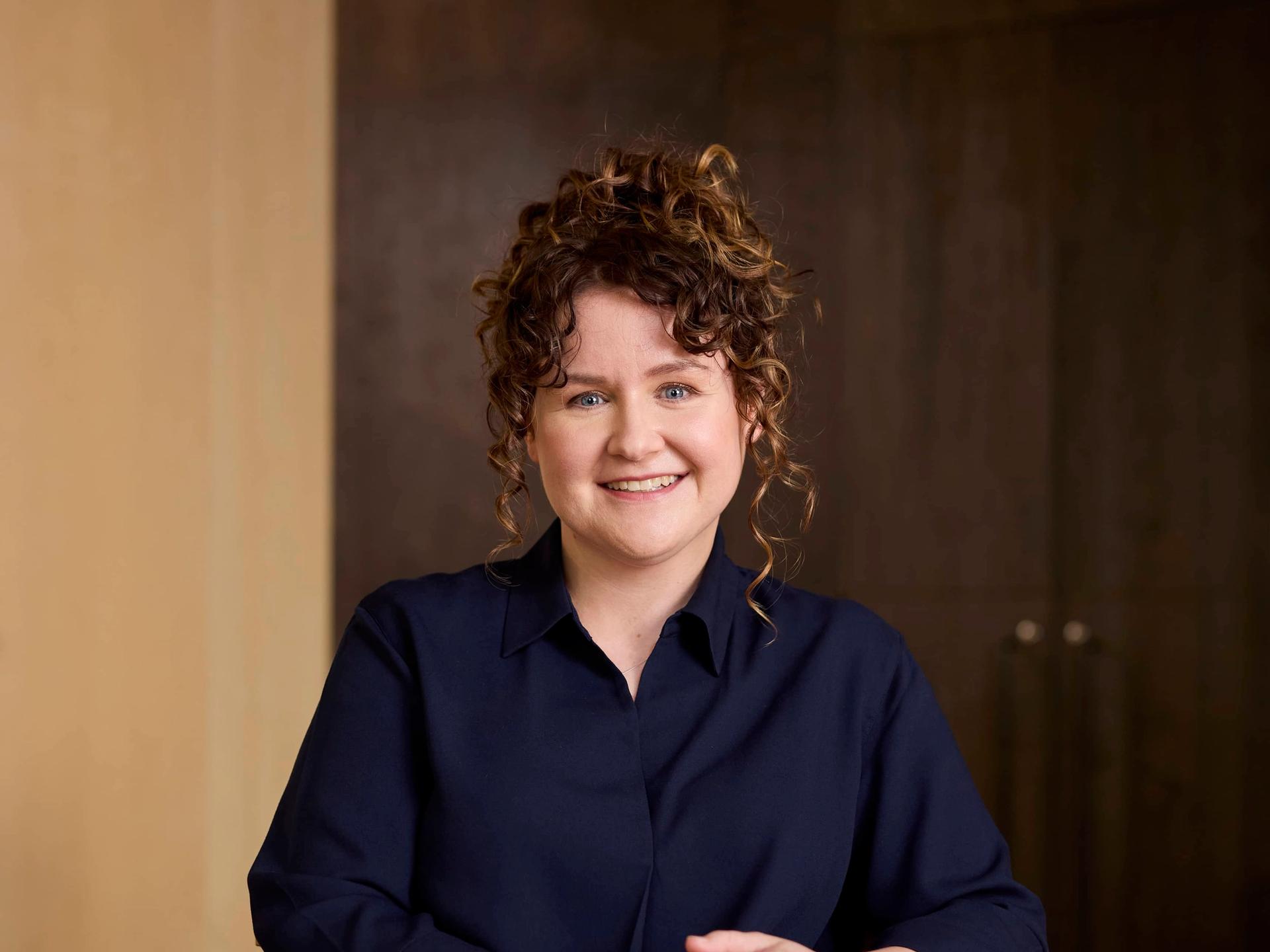 Woman sitting in being a wooden table in an office