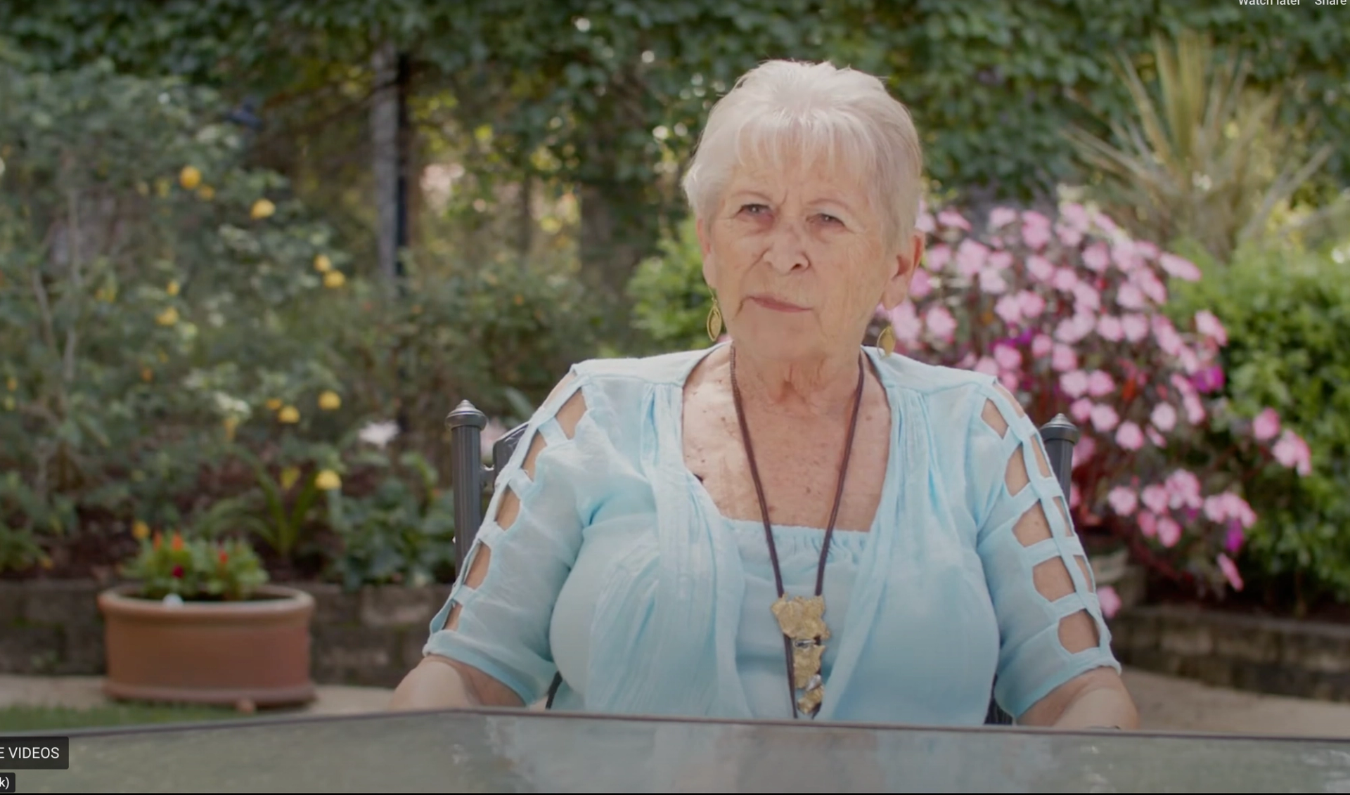 A women sitting on a chair in a garden