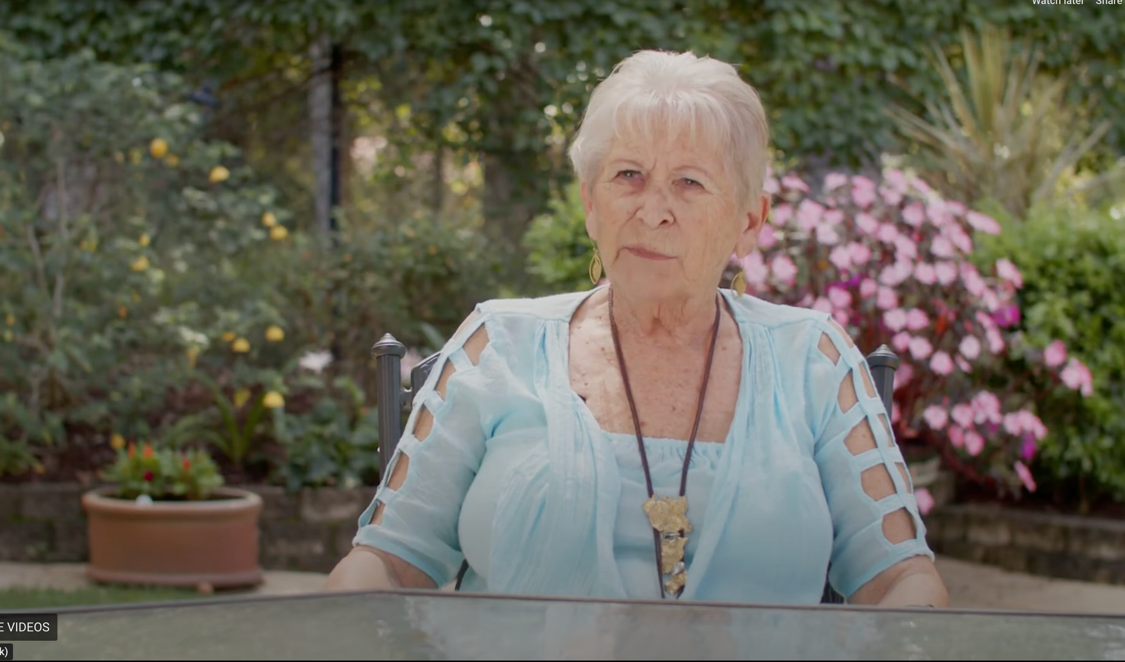 Lady sitting on a chair in a garden