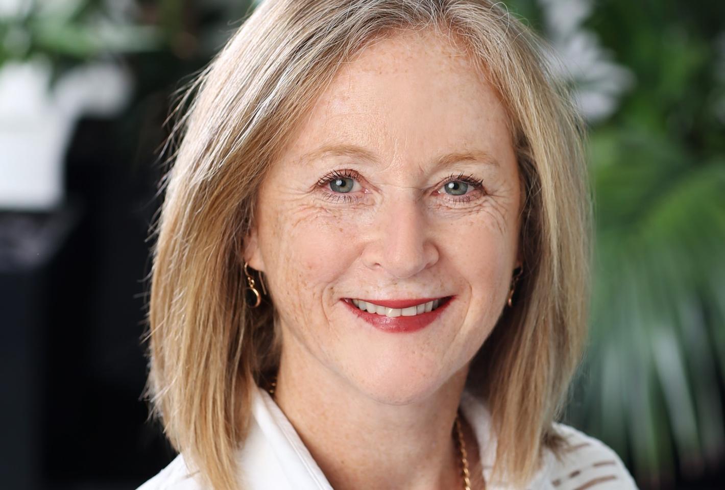 Woman standing in front of green plant