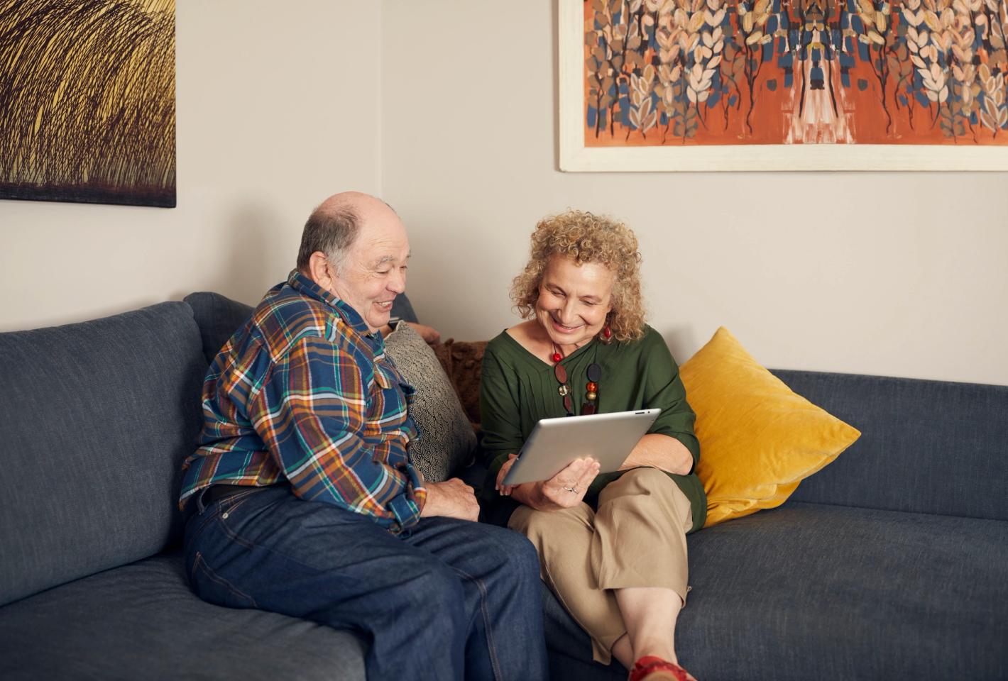 Household Capital customers on the couch with iPad