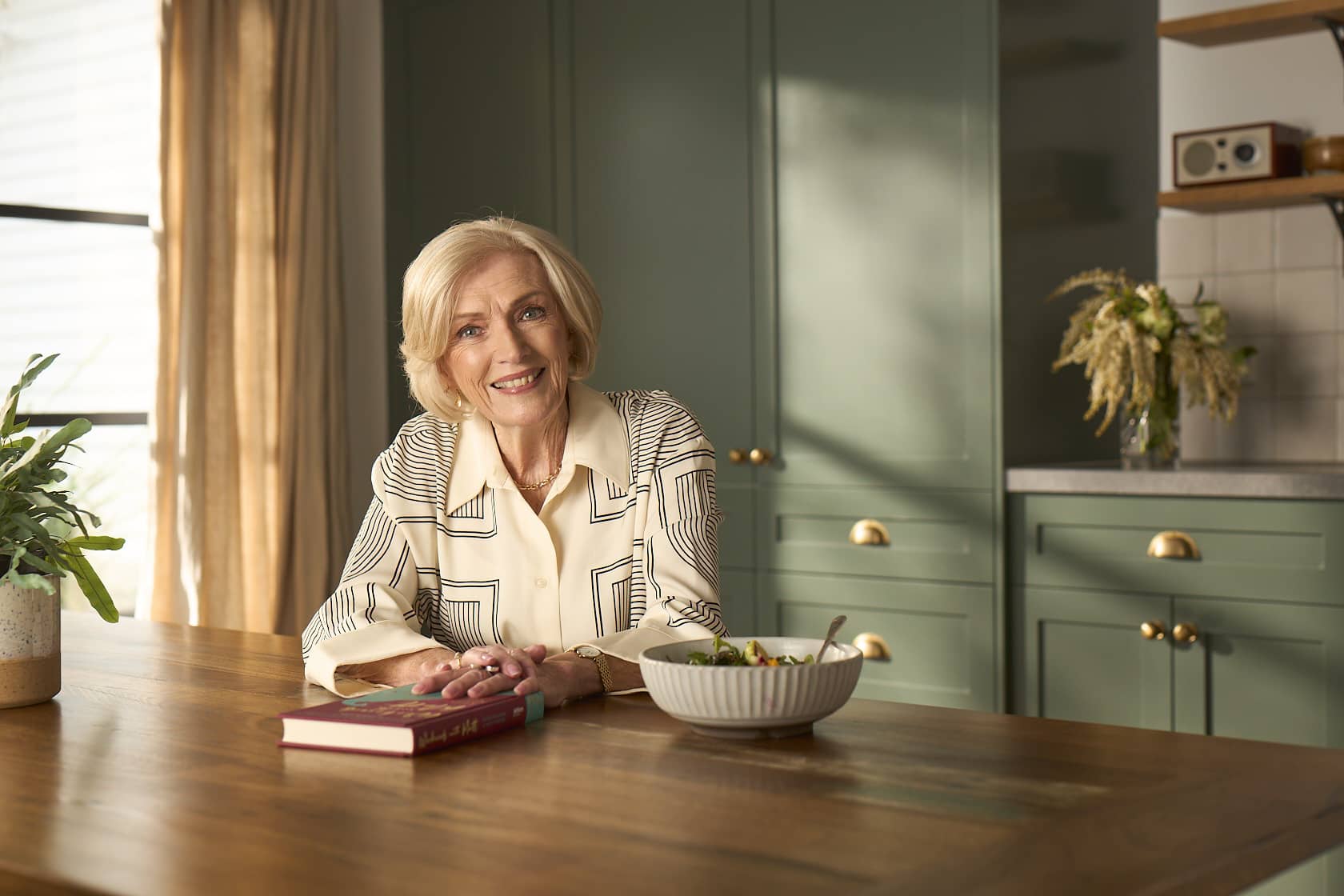 A woman sitting on her bed holding her handbag
