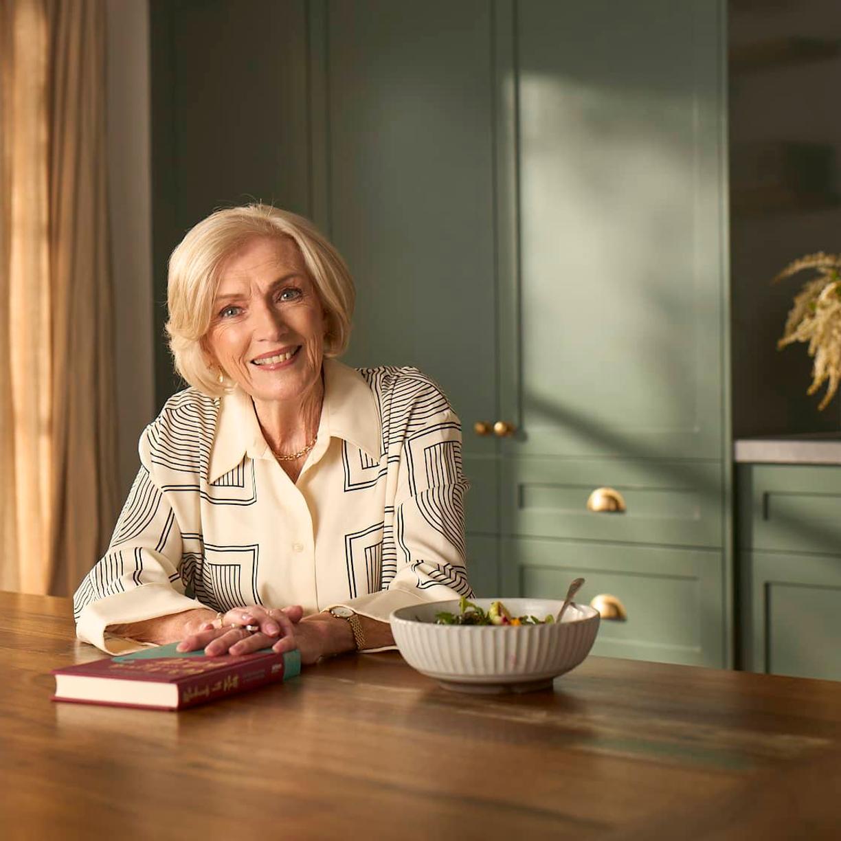 A woman sitting on her bed holding her handbag