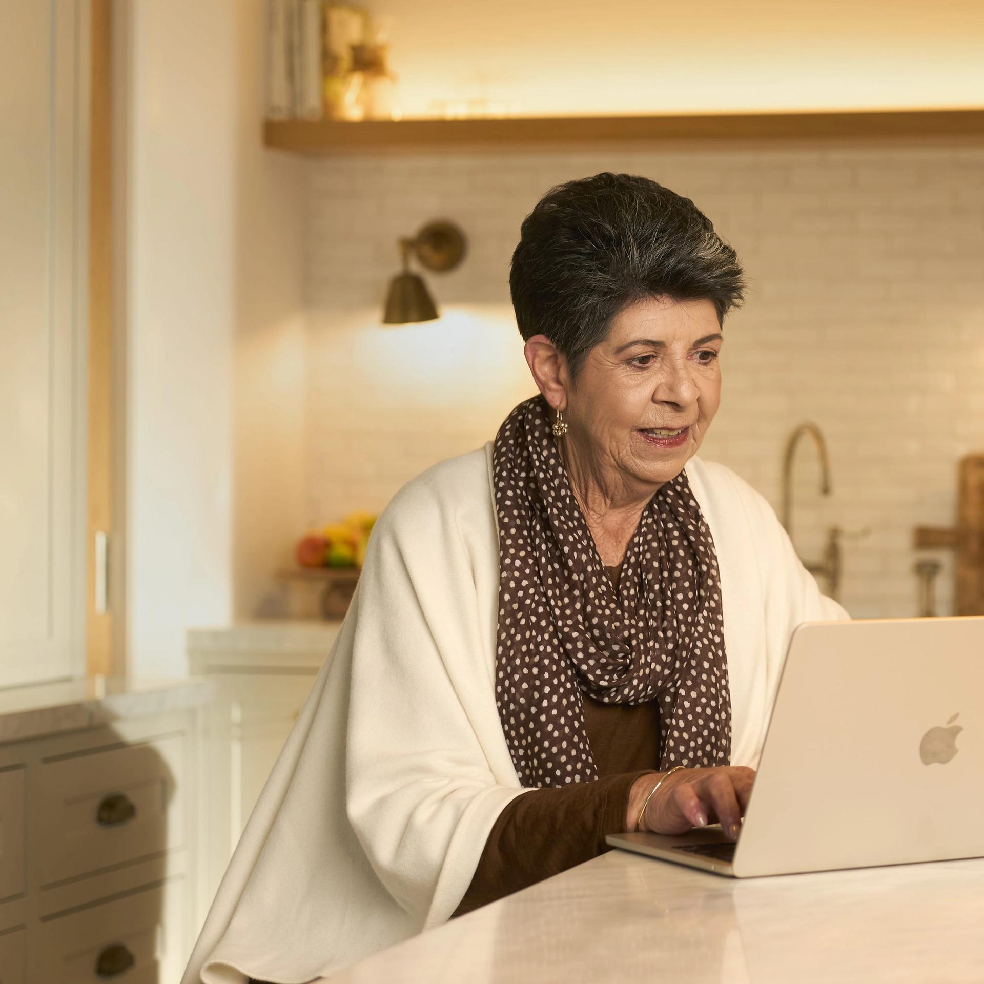 Lady sitting down using a laptop