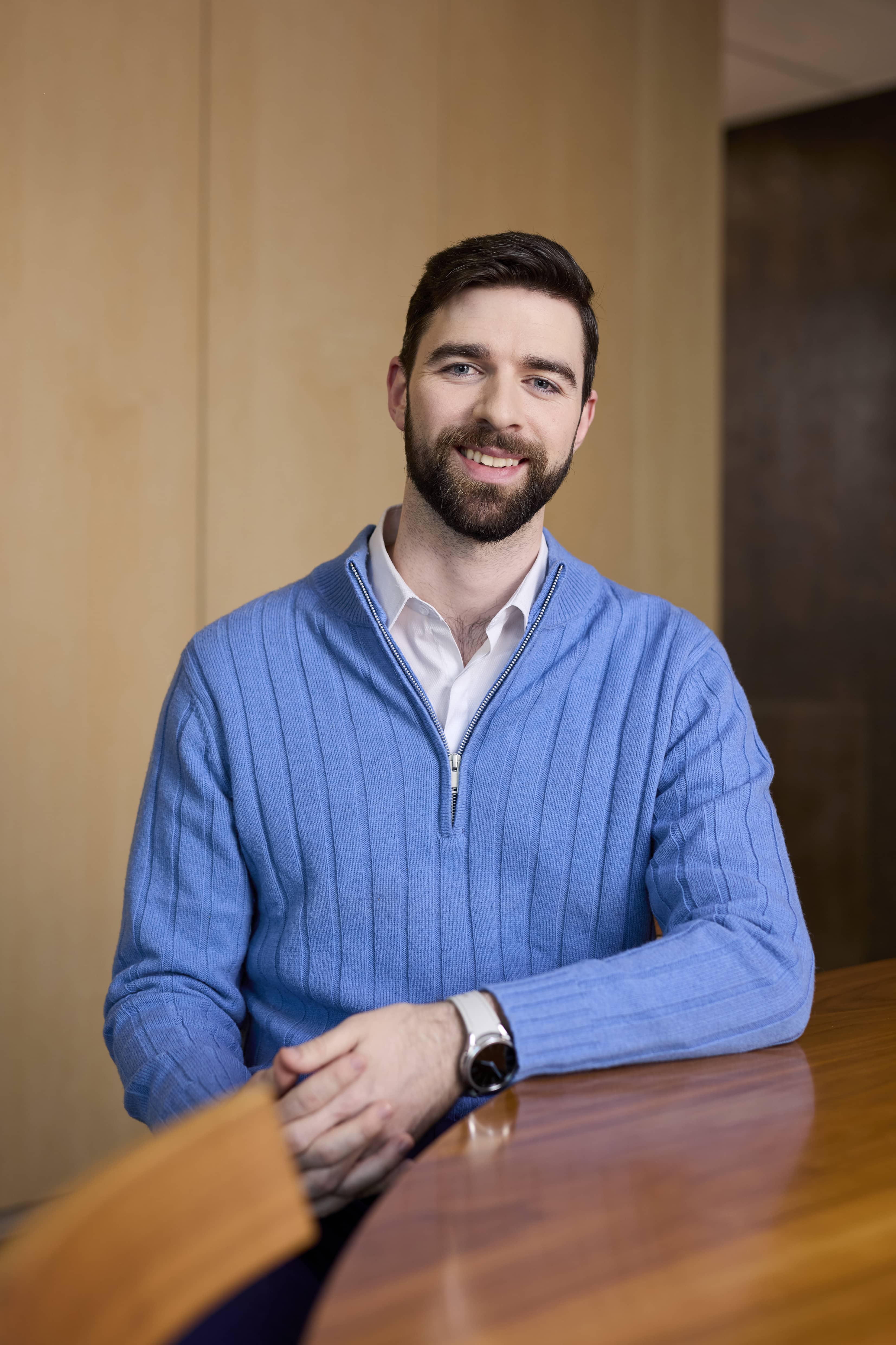 Man sitting at a wooden desk in an office