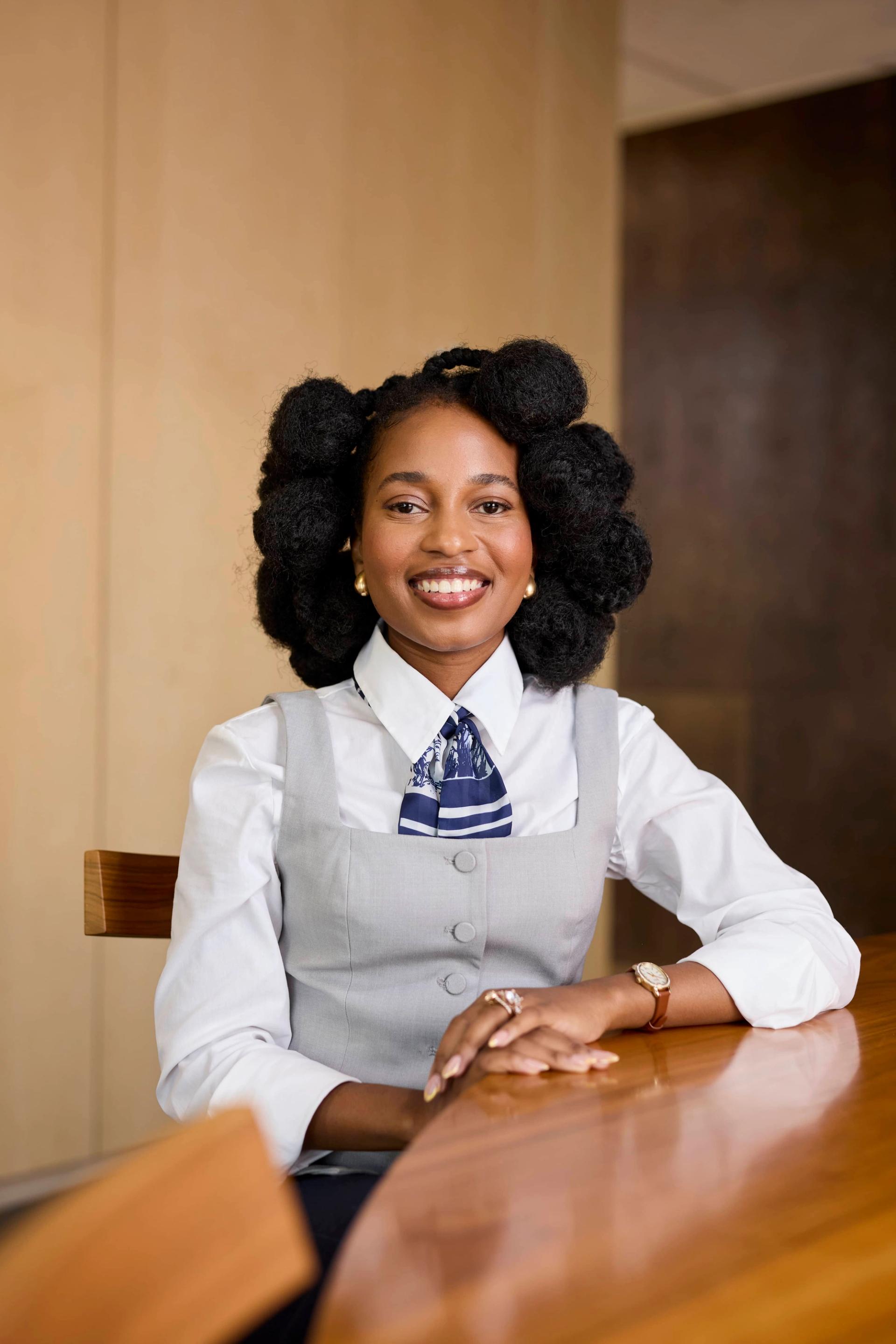 Woman sitting behind a wooden table in an office