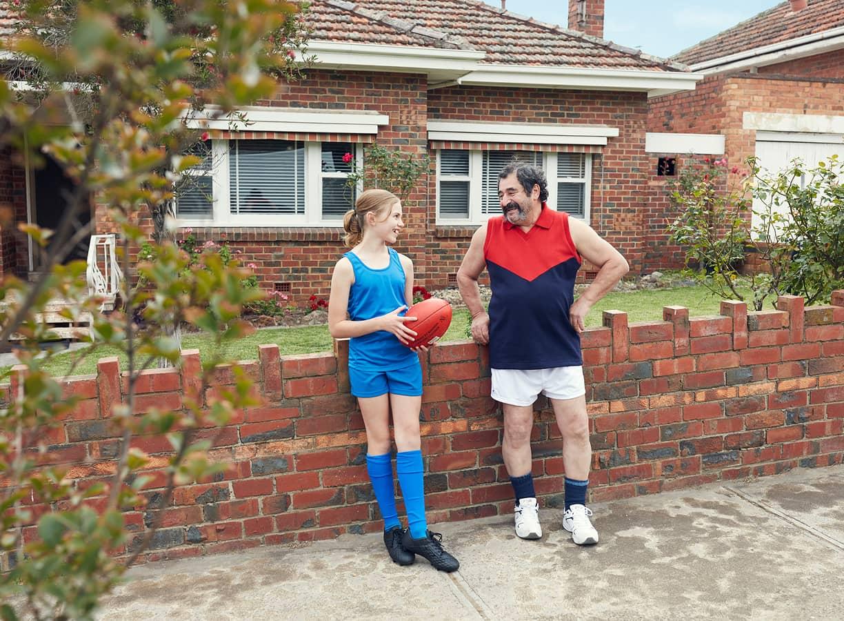 Happy family outside home in sports gear