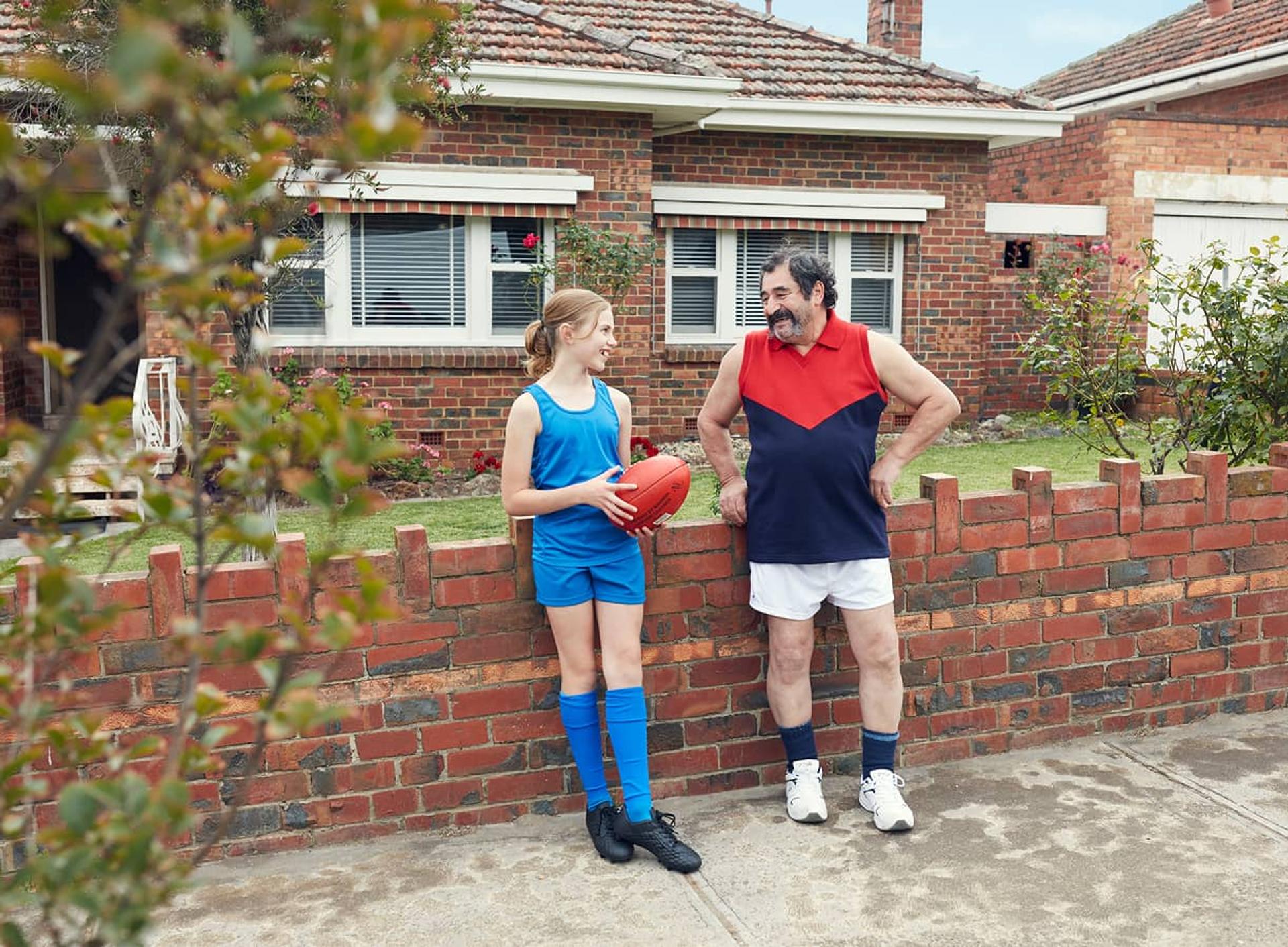 Happy family outside home in sports gear