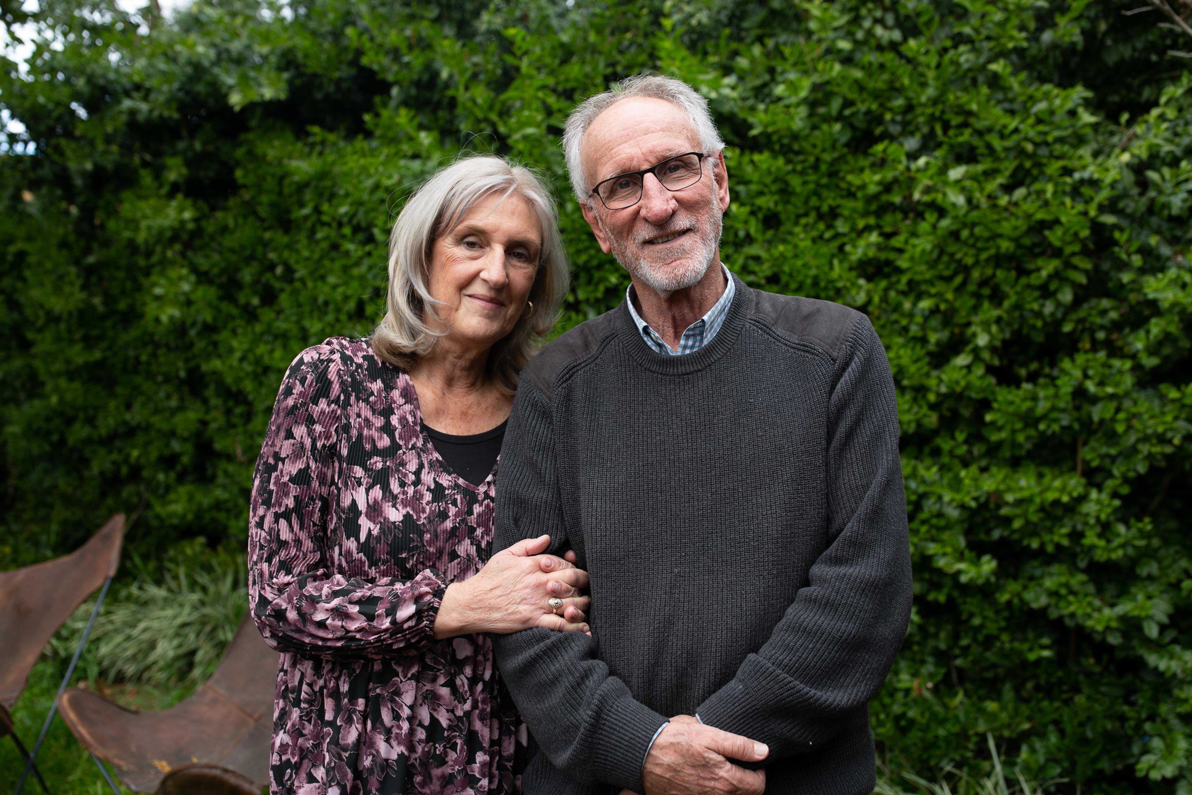 Couple standing in a backyard
