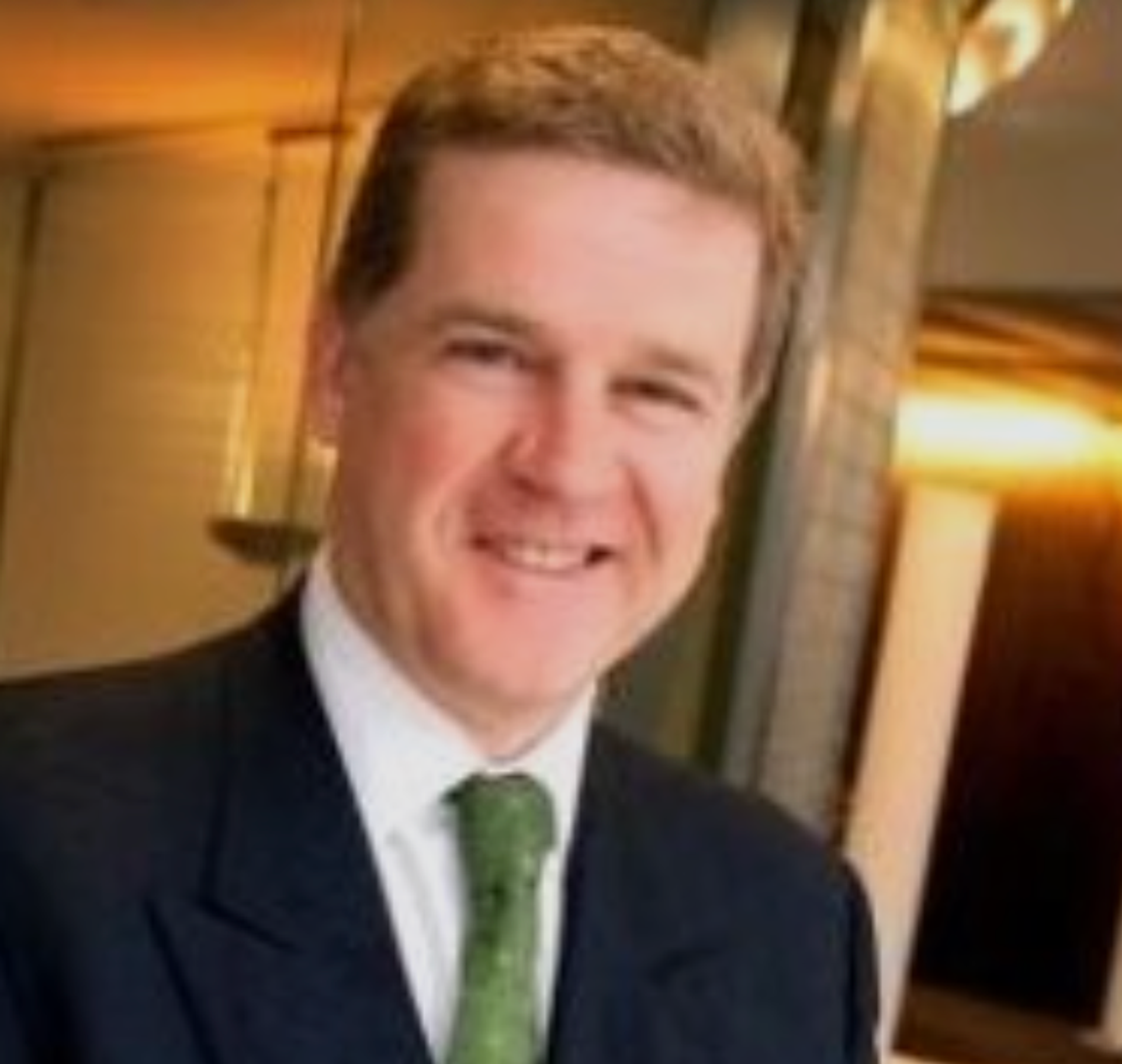 Man smiling in a suit