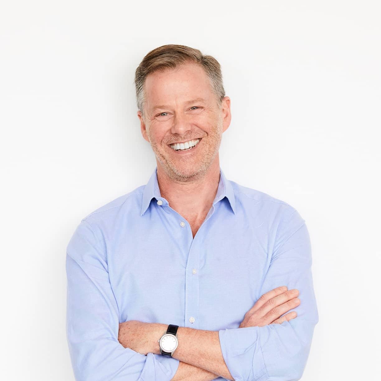 Image of smiling man in blue shirt