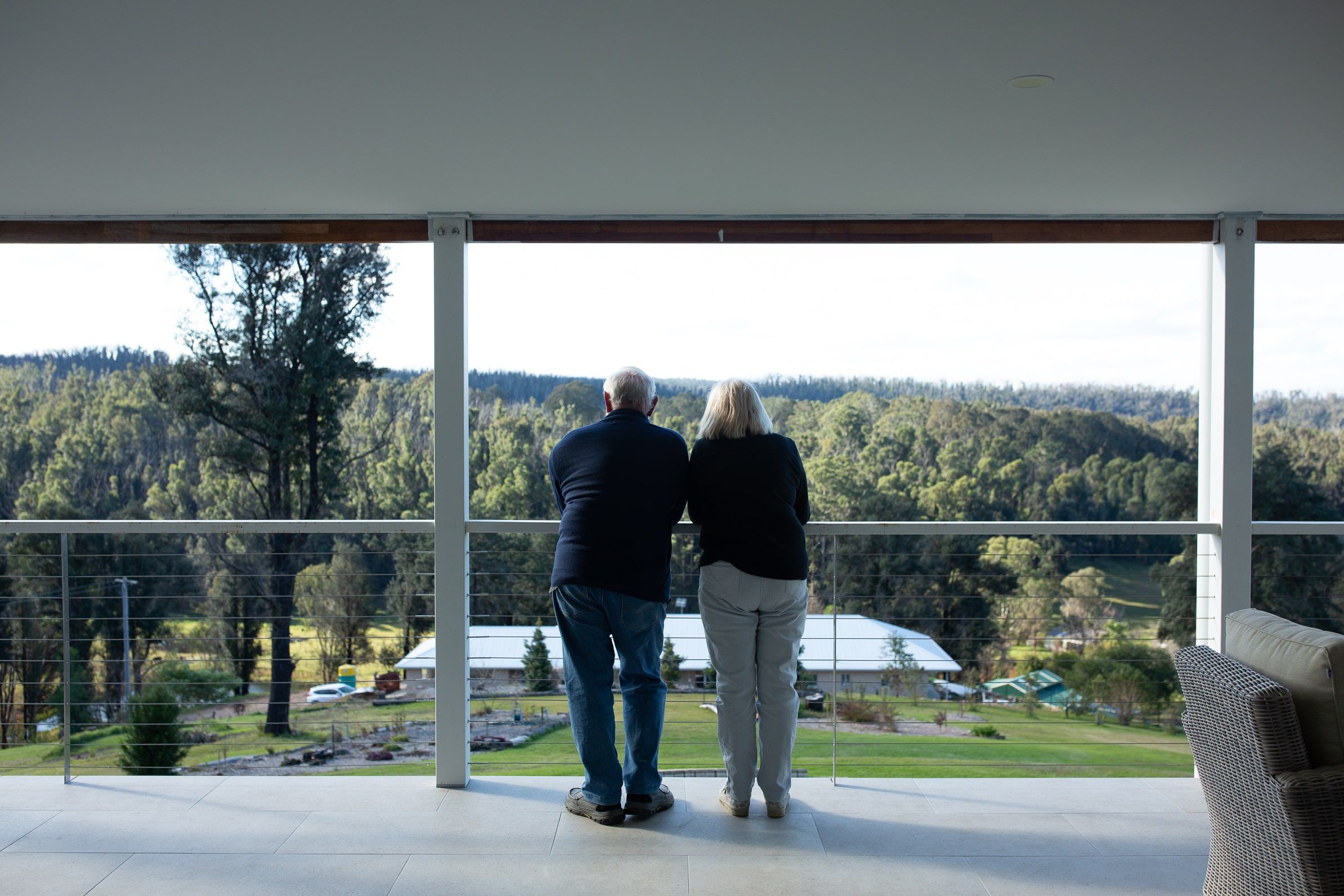 A couple look out at the view from their property