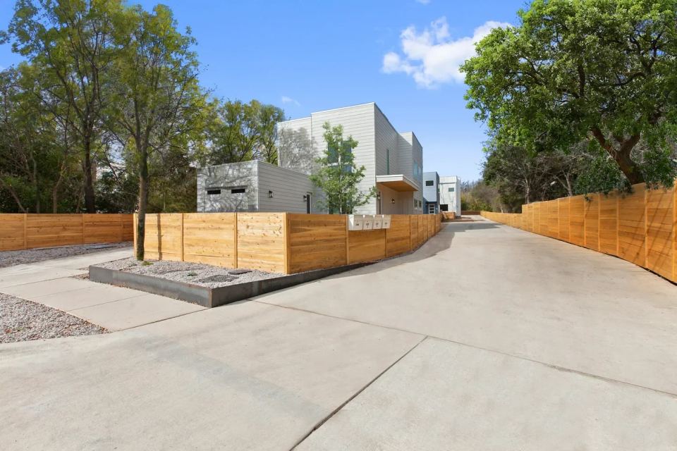 Modern residential development with timber fencing and a shared drive
