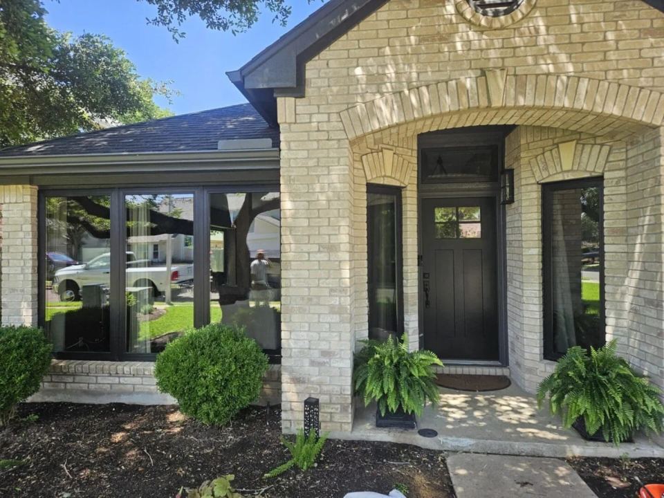 Residential entry with brick walls and black-framed windows