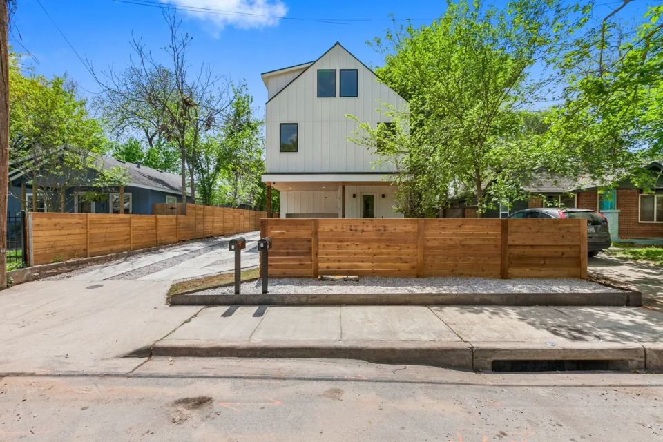Modern two-story residence behind a timber fence