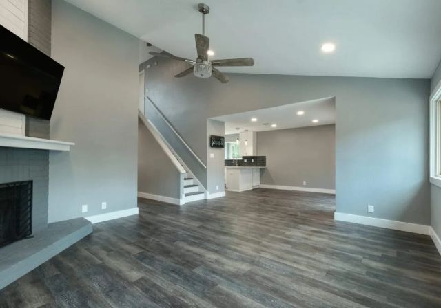 Open living and dining area with timber ceiling beams