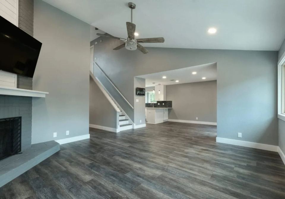 Open living and dining area with timber ceiling beams