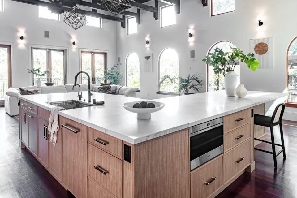 Two tone kitchen remodel blue island white cabinets wood floor