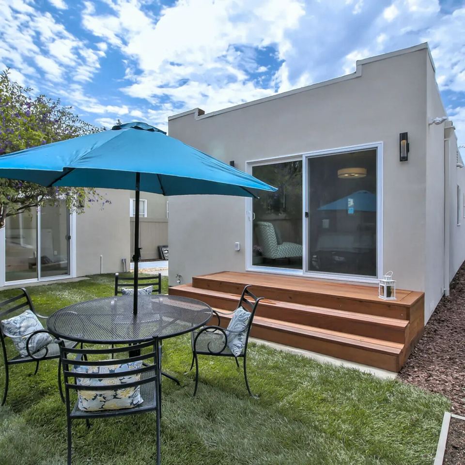Finished backyard patio and deck beside a home
