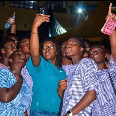 Students reach for the sky, capturing the moment during a night outreach event.