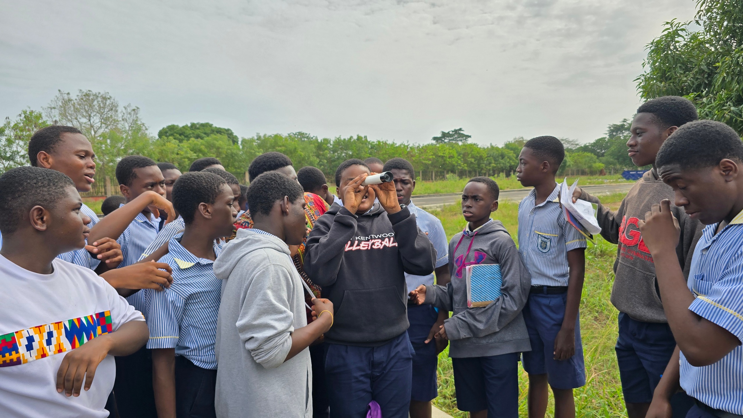 Students take turns at the finderscope under the open sky.