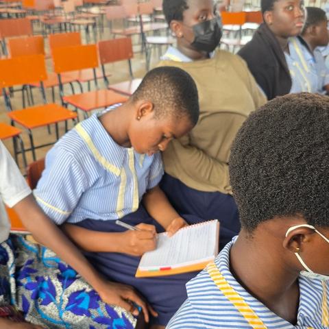 Students take notes during a hands-on STEM workshop.
