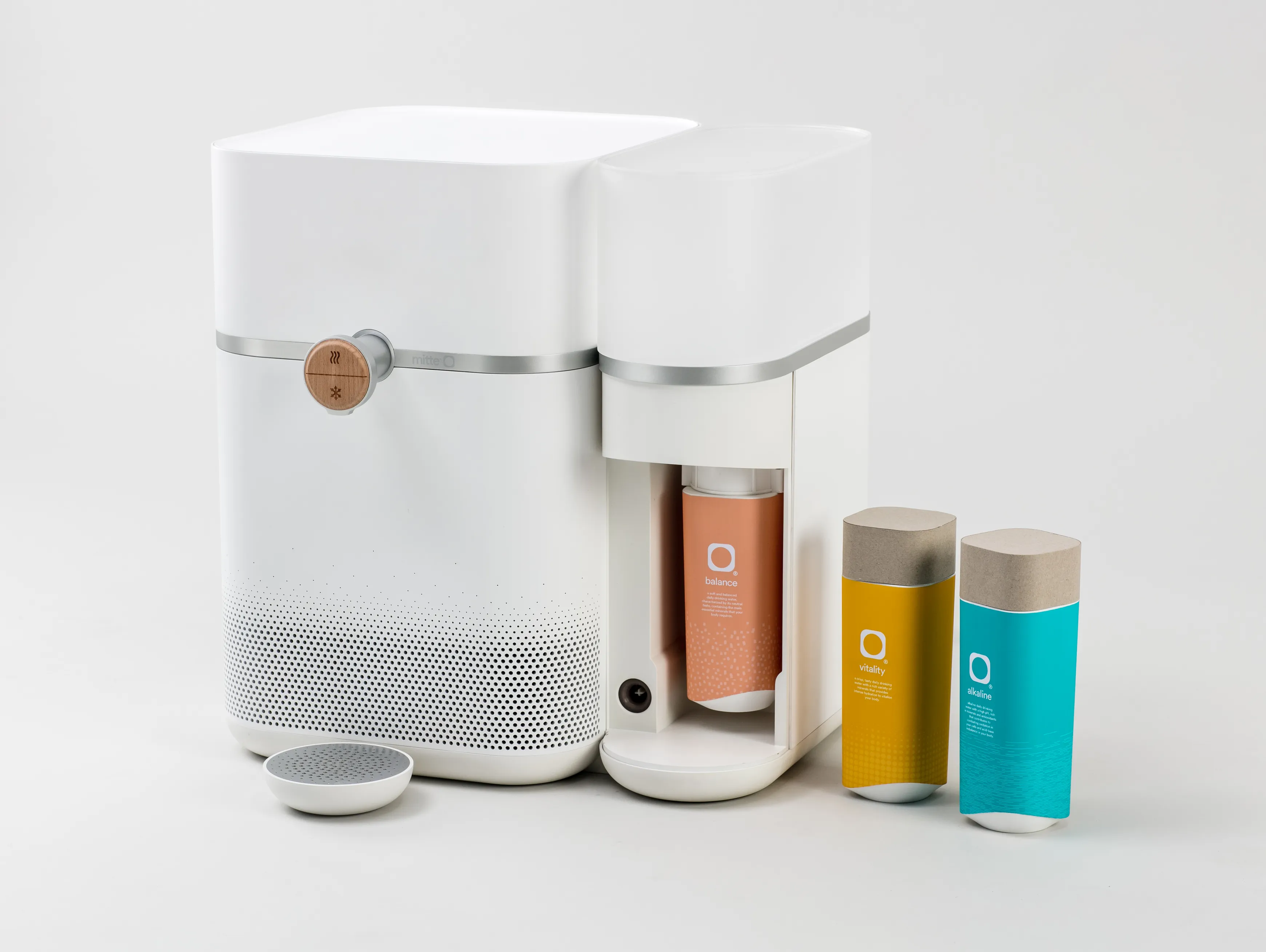 The Mitte water purifier with its panel taken off displaying the purification cartridges