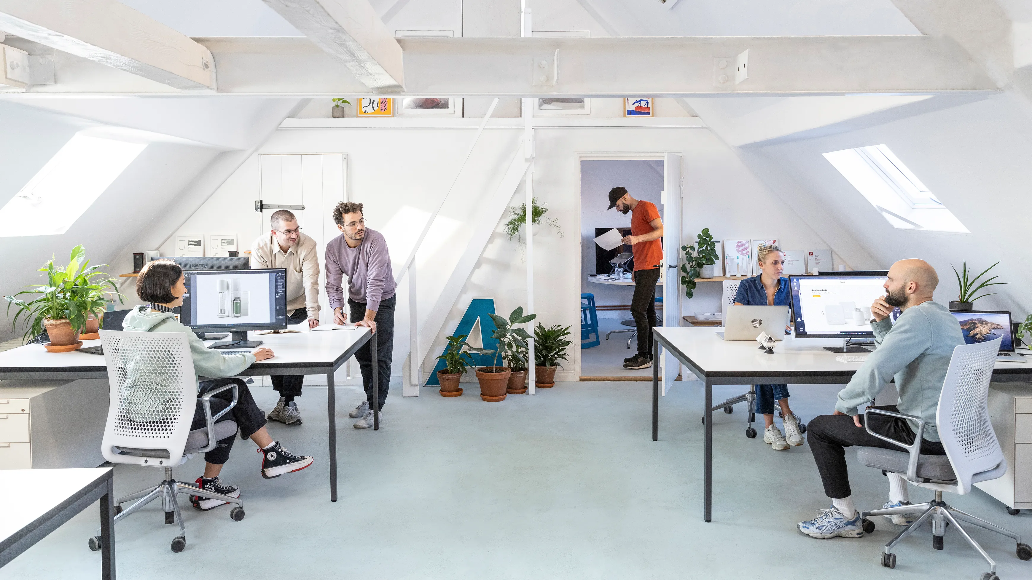 A view inside a sunny industrial design studio with its employees