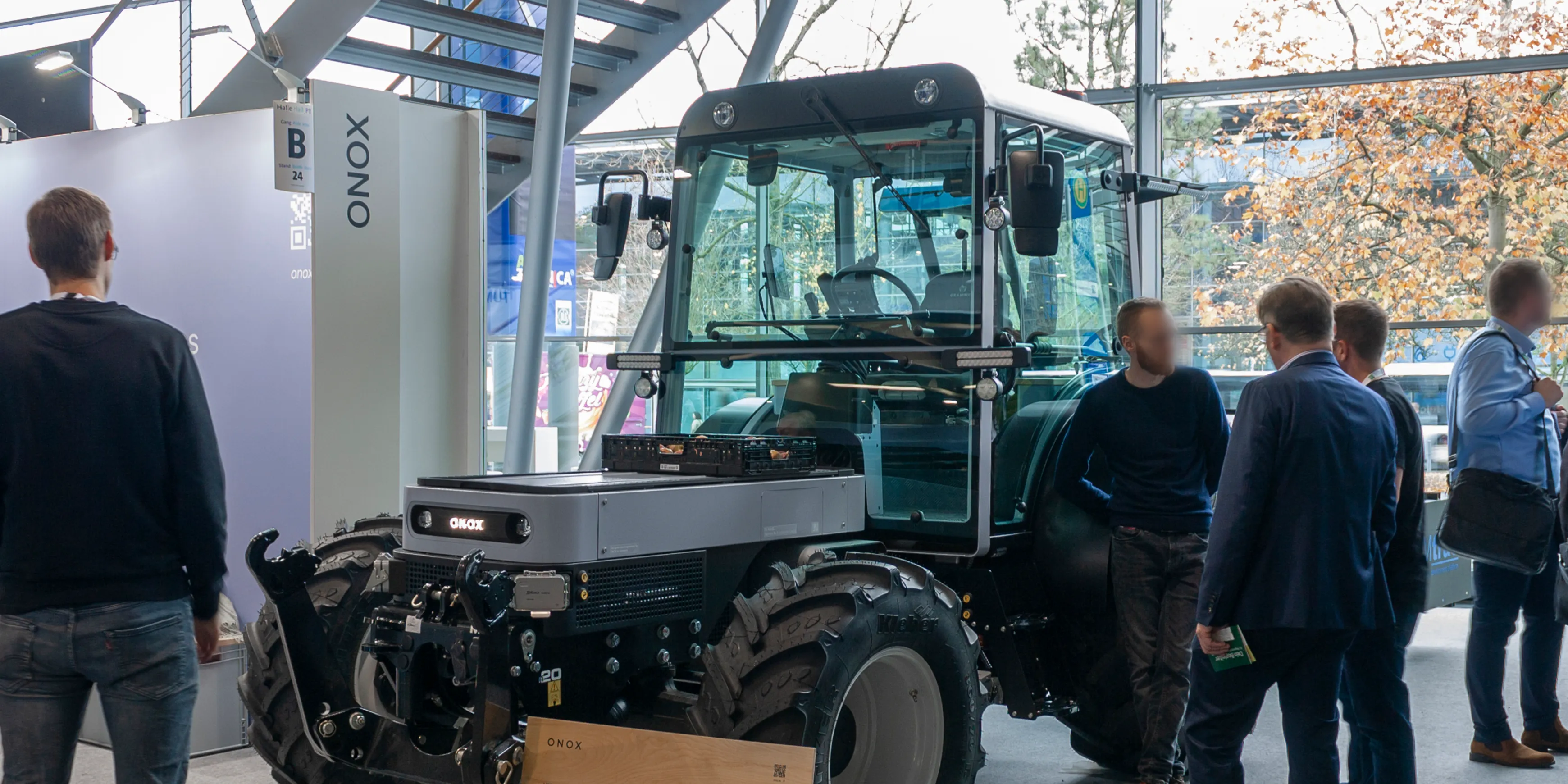 The Onox electric tractor at a agriculture fair with visitors around it