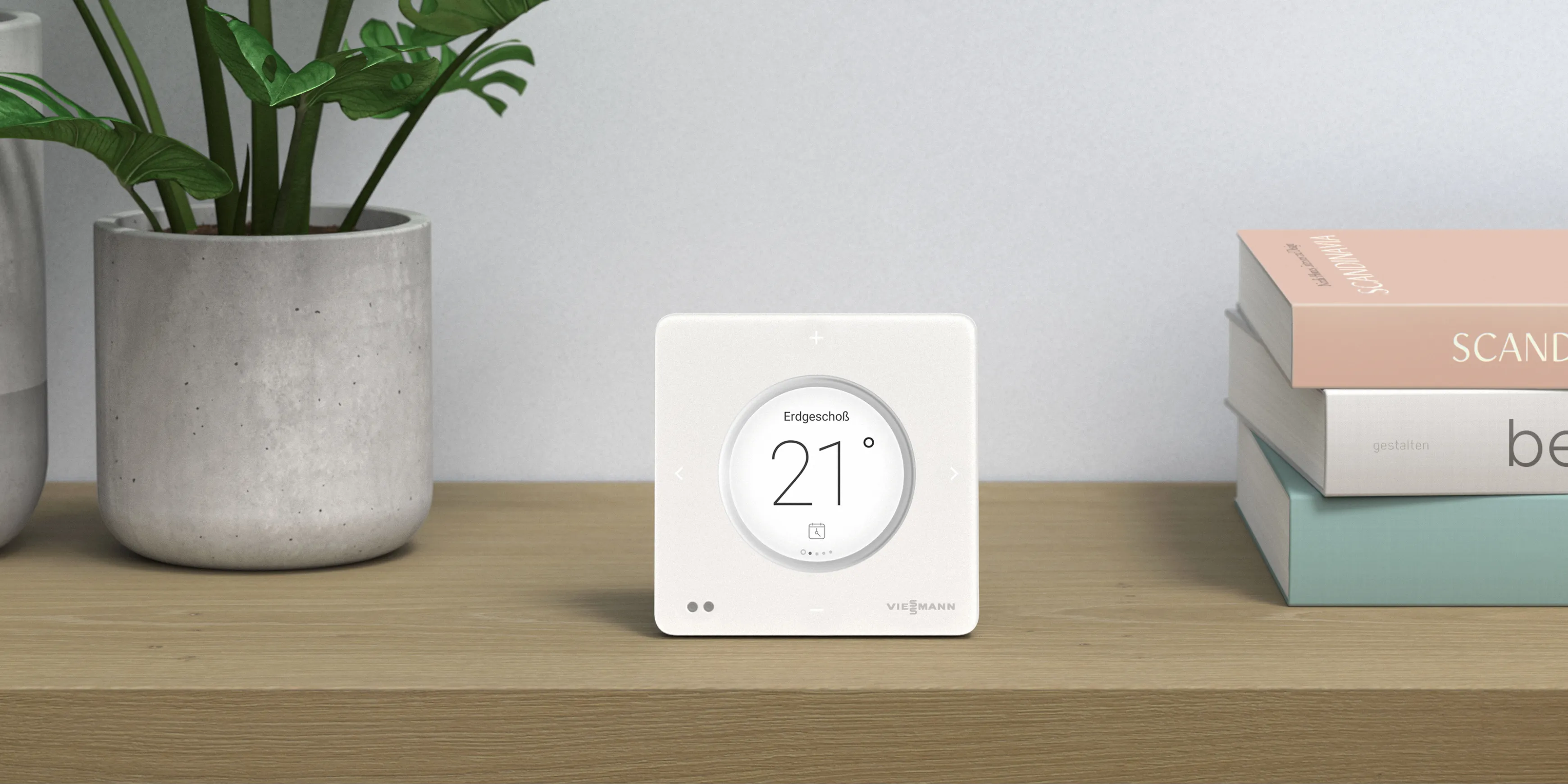 A Viessmann ViCare smart heating thermostat standing on a wooden shelf