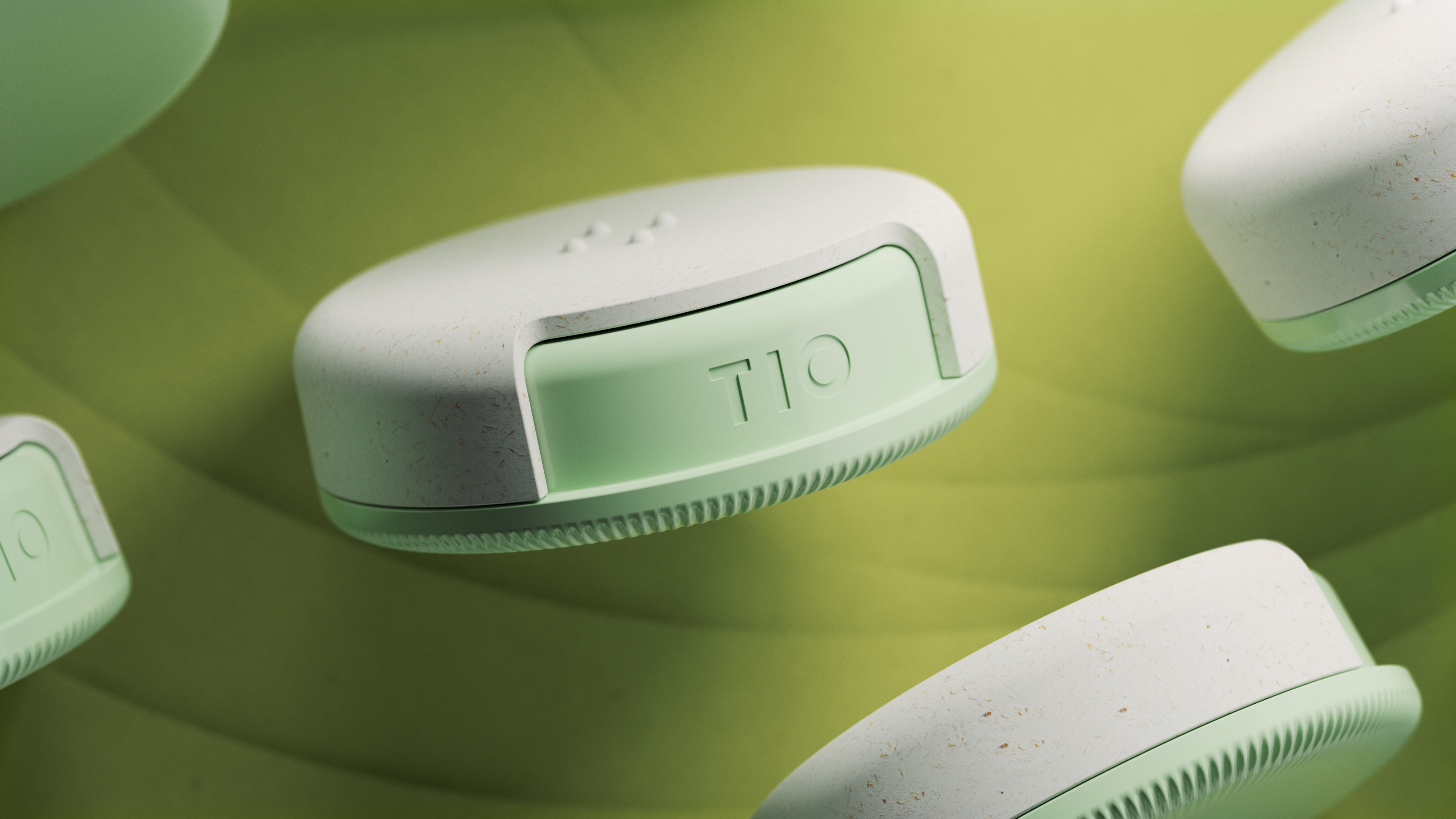 TIO floss dispesner floating in front of a green background