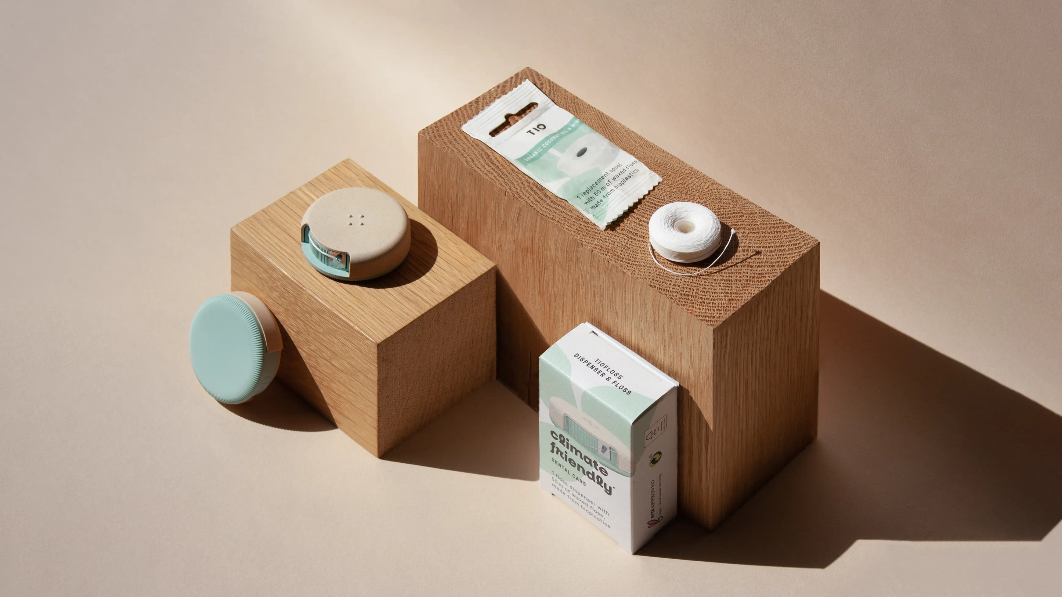 TIO floss products and packaging on display on wooden blocks
