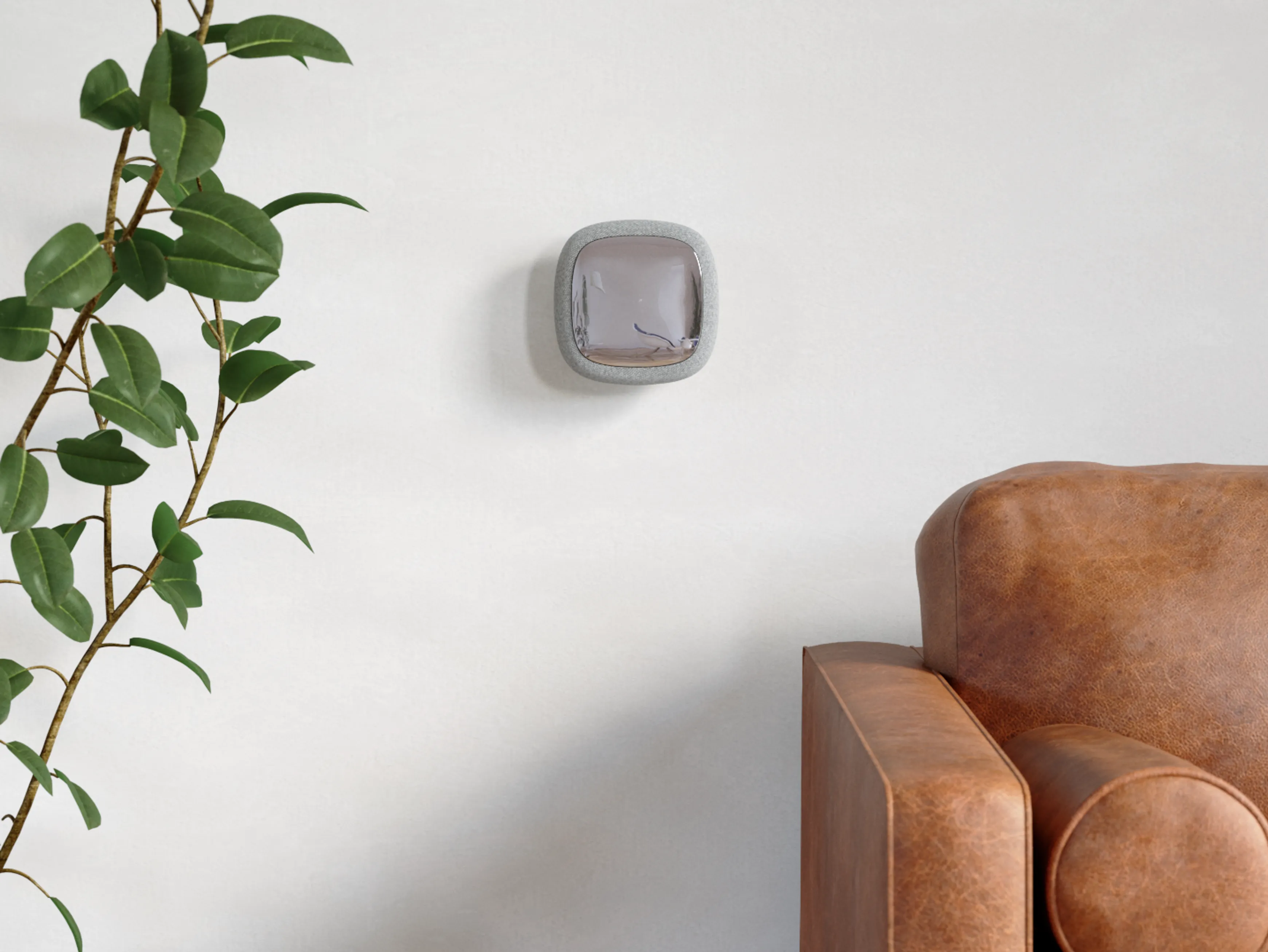 Front view of the Livy smart living assistant mounted on a wall next to a sofa