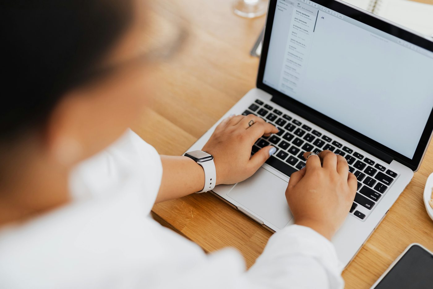 Image showing a person working on her laptop.