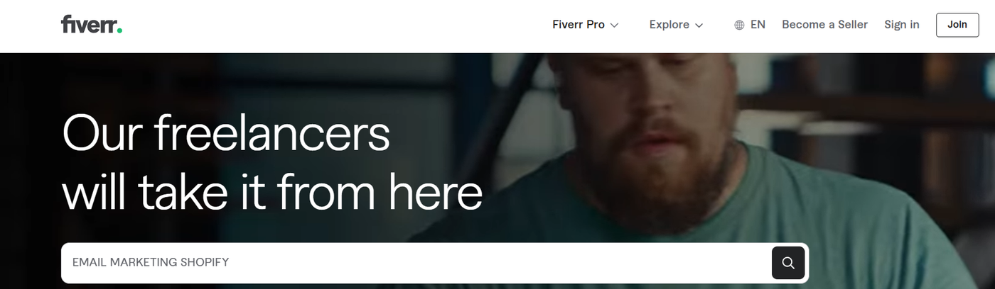 Screenshot of the Fiverr search page showing the search bar with the text “EMAIL MARKETING SHOPIFY” and related freelancer listings below.