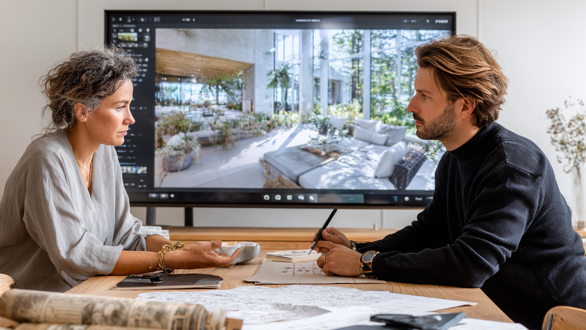 Architect discussing design options with a client using an AI-generated render to preview the proposed space