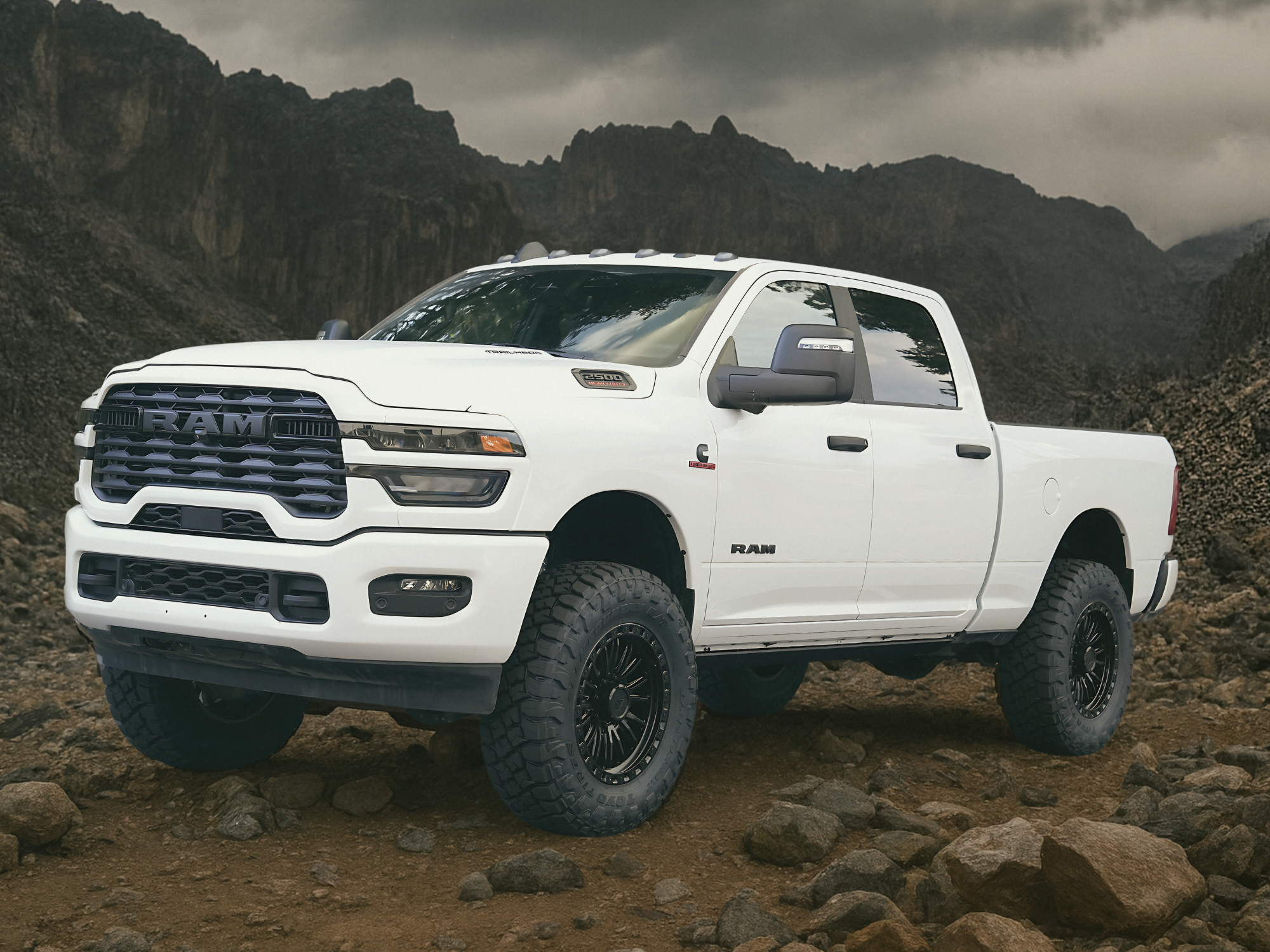 a white ram truck is parked in a rocky area built by TimberlineUpfitters
