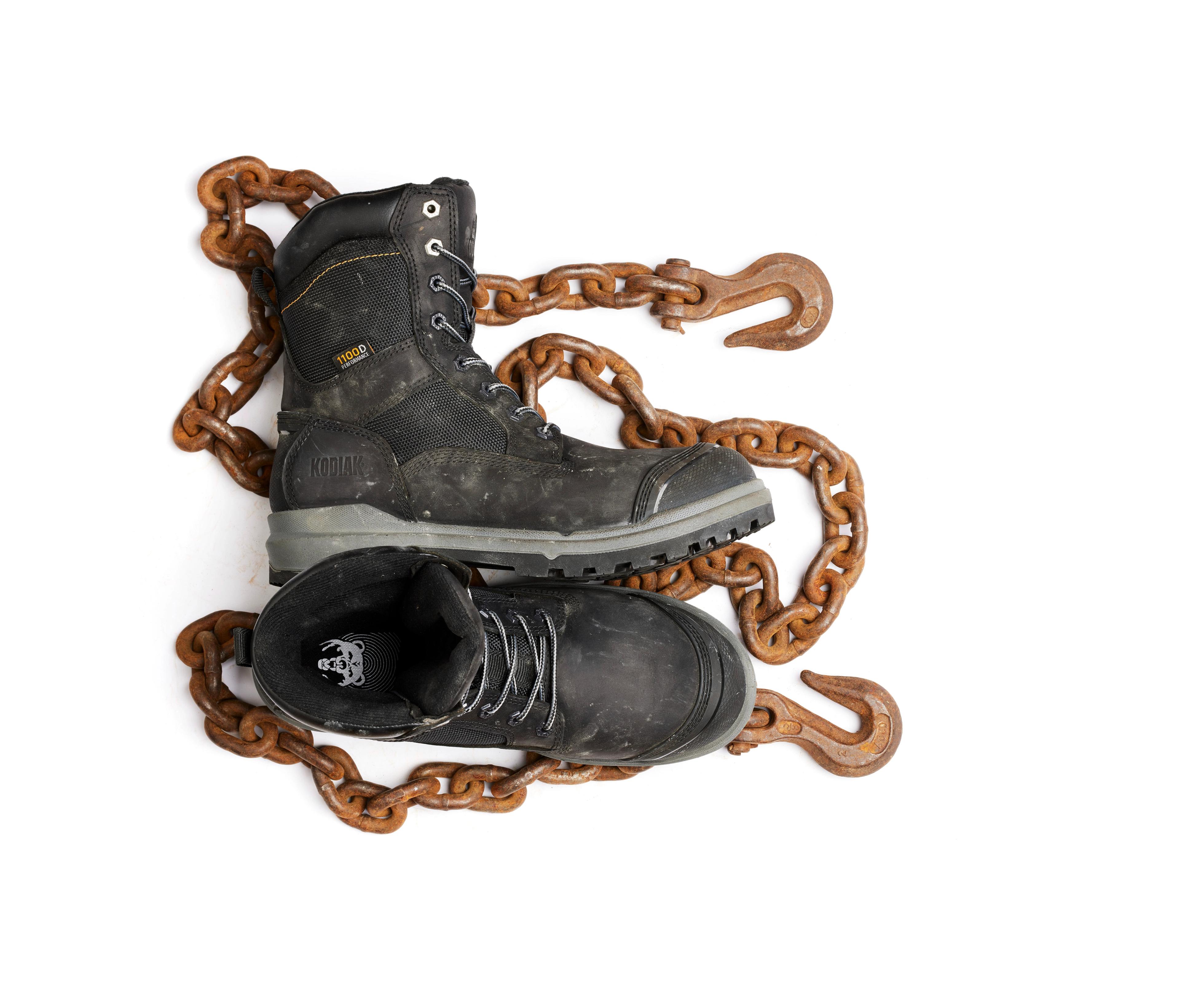 kodiak black work boots  with rusty chain background creative photography