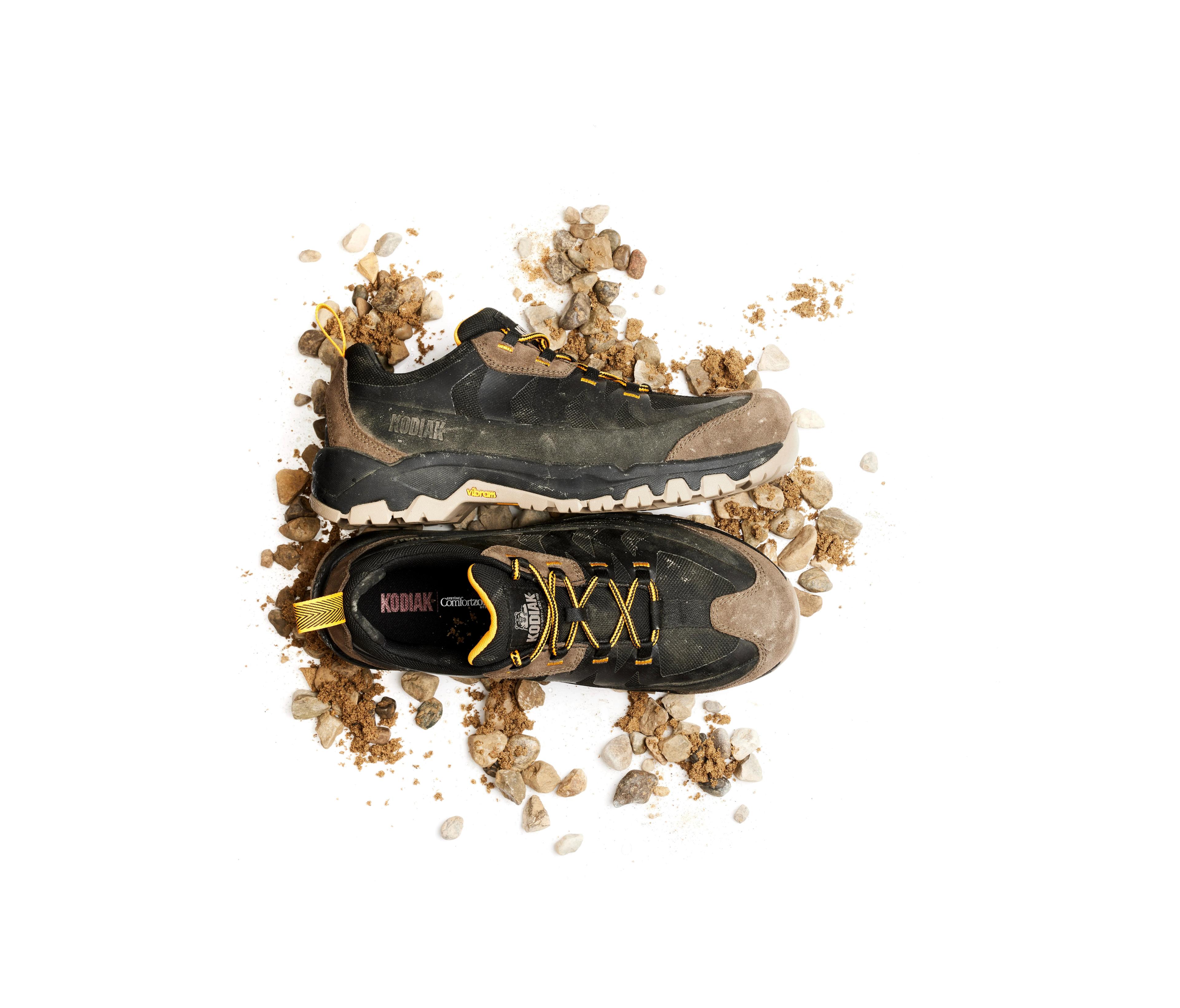 kodiak work shoes rugged pair with rocks in the background overhead product photo